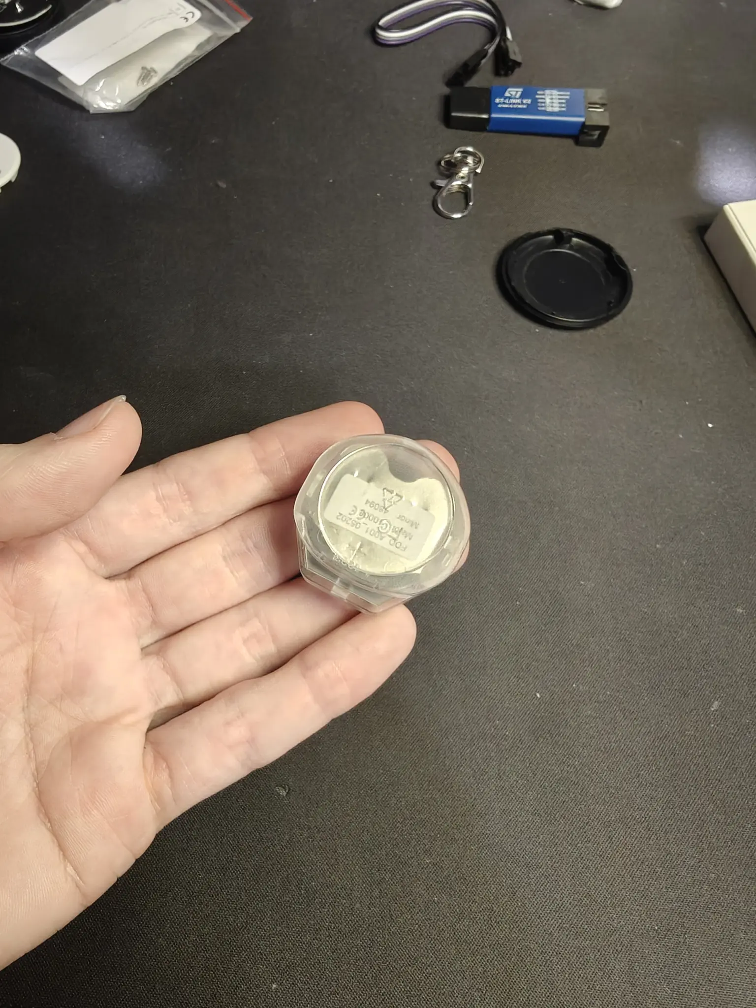 the PCB in its transparent case, in a similar weird shape